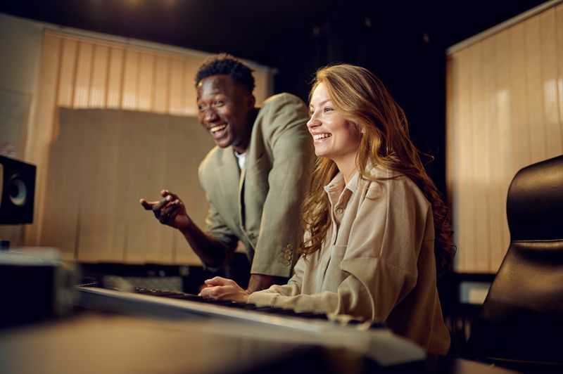 Two engineers reviewing work at a mixing console